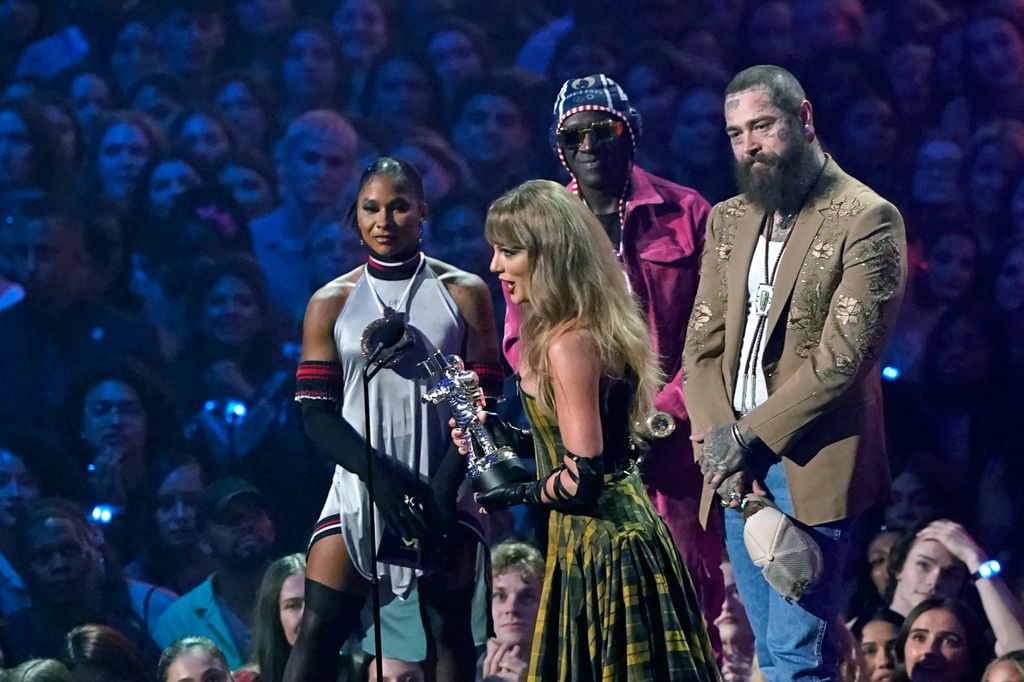 US singer-songwriter Taylor Swift (C) and US rapper Post Malone (R) accept the Best Collaboration award for "Fortnight" on stage during the MTV Video Music Awards