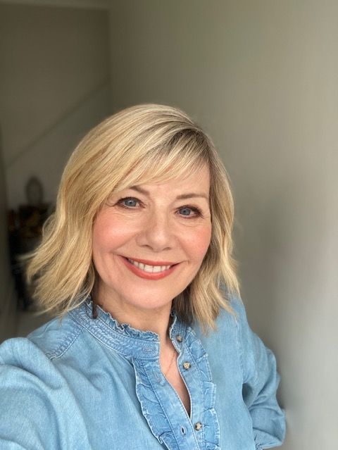 Woman taking a selfie in a denim shirt