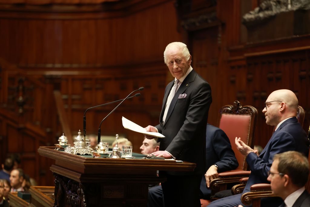 King Charles reading a speech inside Italy's parliament building