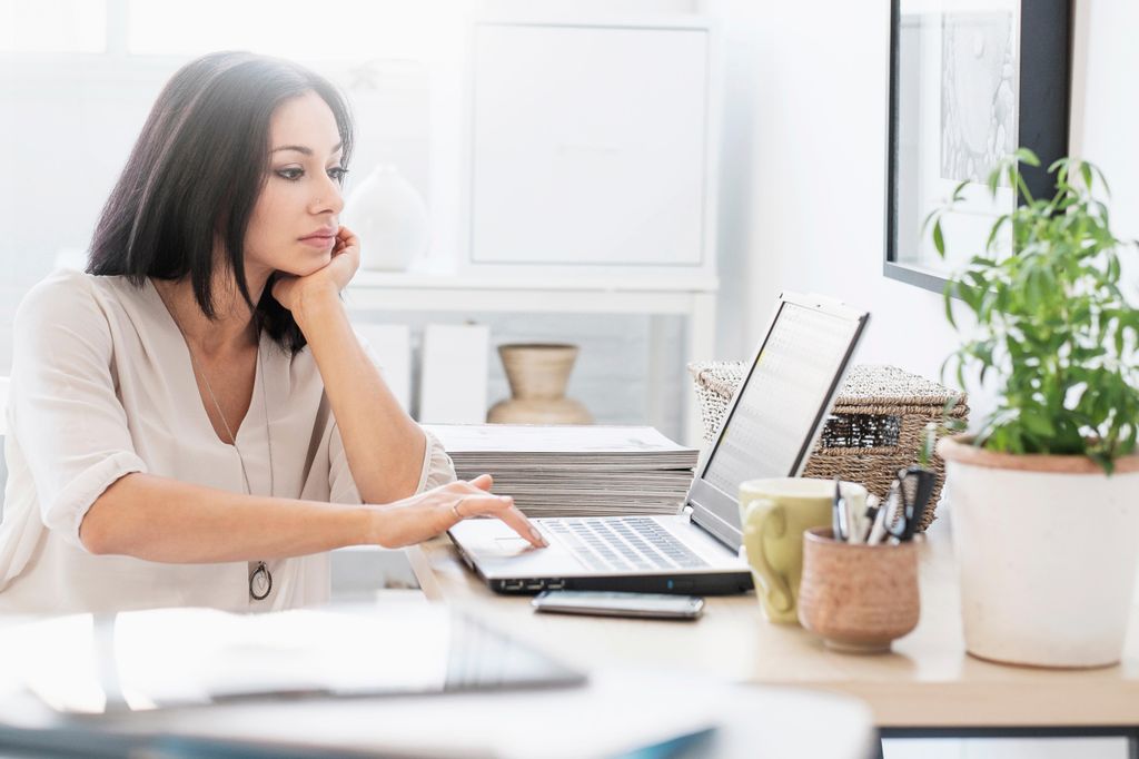 Stock image of woman sitting at desk with laptop