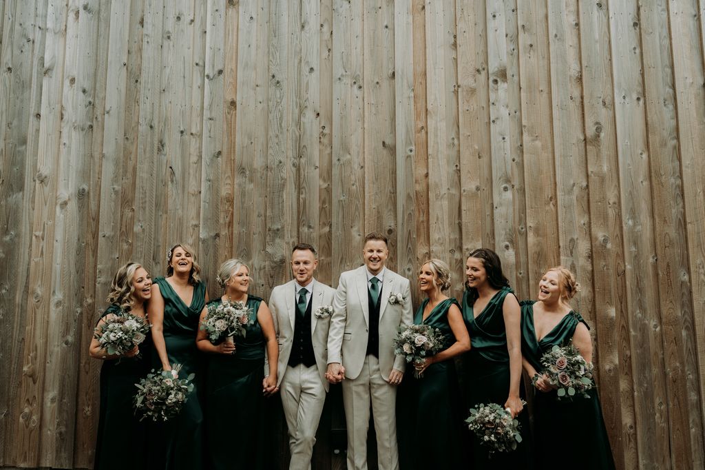 Couple with their bridesmaids dressed in green