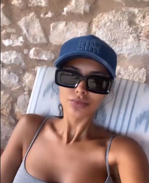 Maya Jama wearing a cap and sunglasses