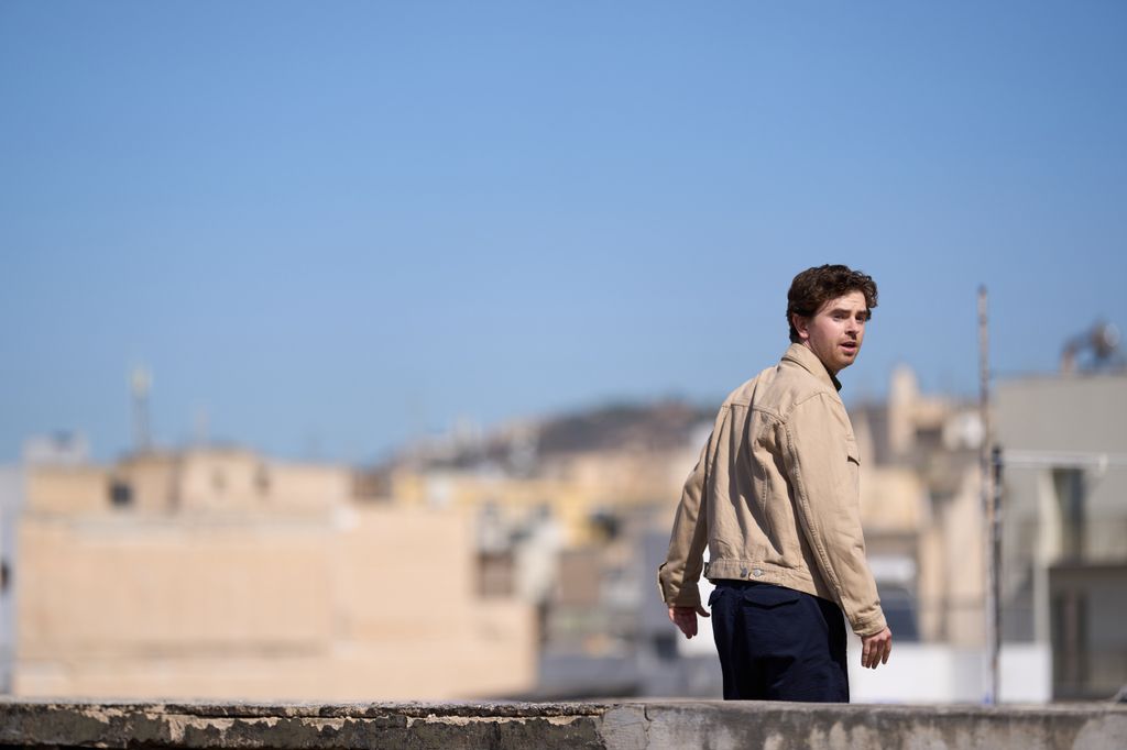 man standing on roof 