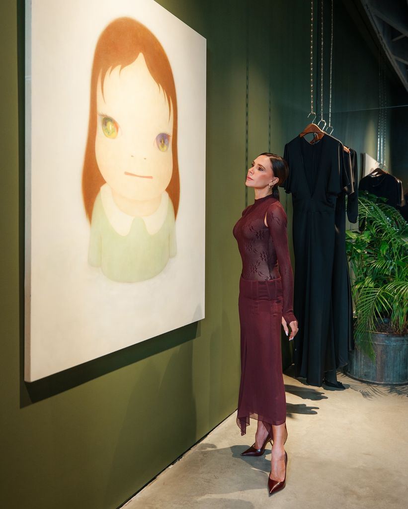 Victoria Beckham staring at a piece of art