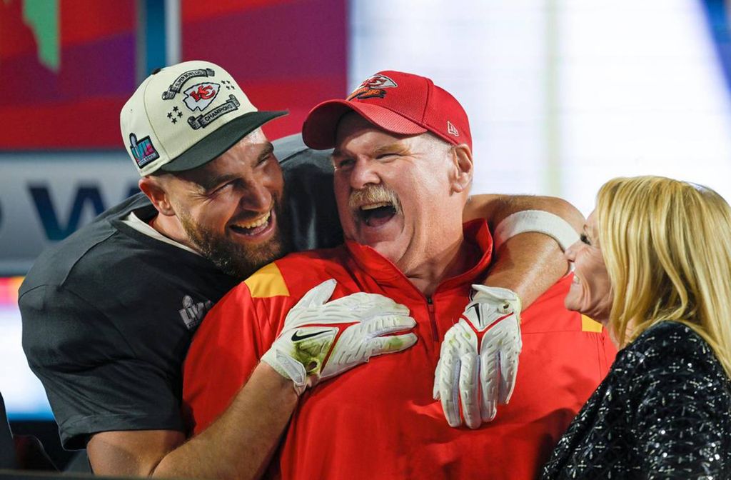 Kansas City Chiefs tight end Travis Kelce (87) hugs Chiefs Head Coach Andy Reid as Tammy Reid looks on after the Chiefs won Super Bowl LVII, defeating the the Philadelphia Eagles, 38-35, on Sunday, Feb. 12, 2023, at State Farm Stadium in Glendale, Arizona