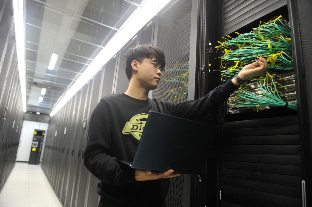 An engineer conducts an inspection in a data center on February 13, 2025  in Urumqi, Xinjiang Uygur 