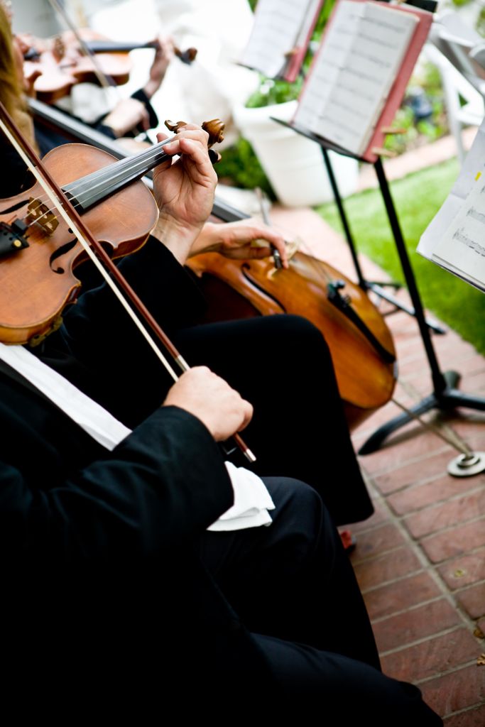 A violinist and a cellist playing at a wedding