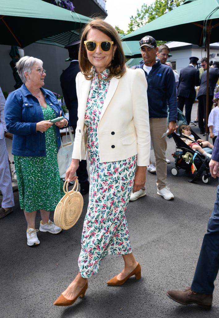A photo of Carole Middleton wearing a tropical print dress and a white jacket