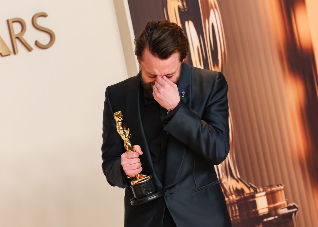 Kieran Culkin looking down in disbelief as he holds his Oscar backstage at the 97th Oscars held at the Dolby Theatre on March 2, 2025 in Hollywood, California