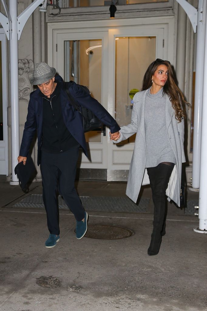 George Clooney and his wife Amal Clooney hold hands as they head out together in New York.