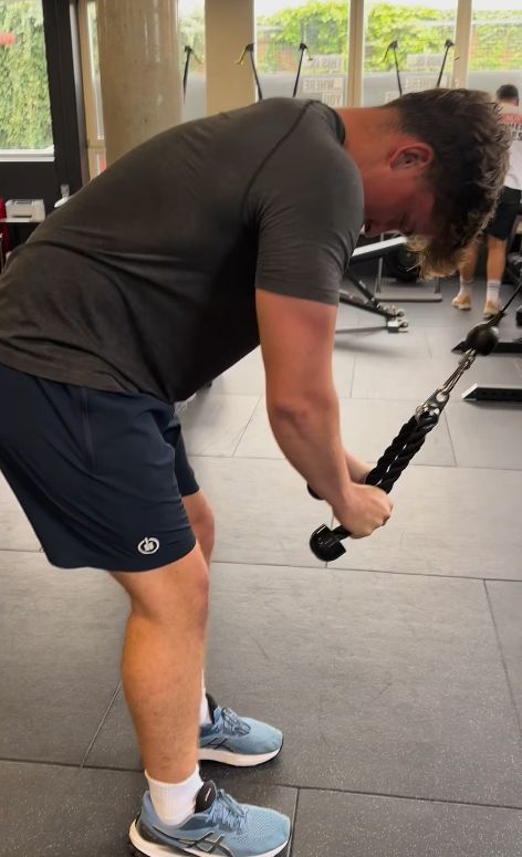 A teenage boy with a resistance equipment at the gym