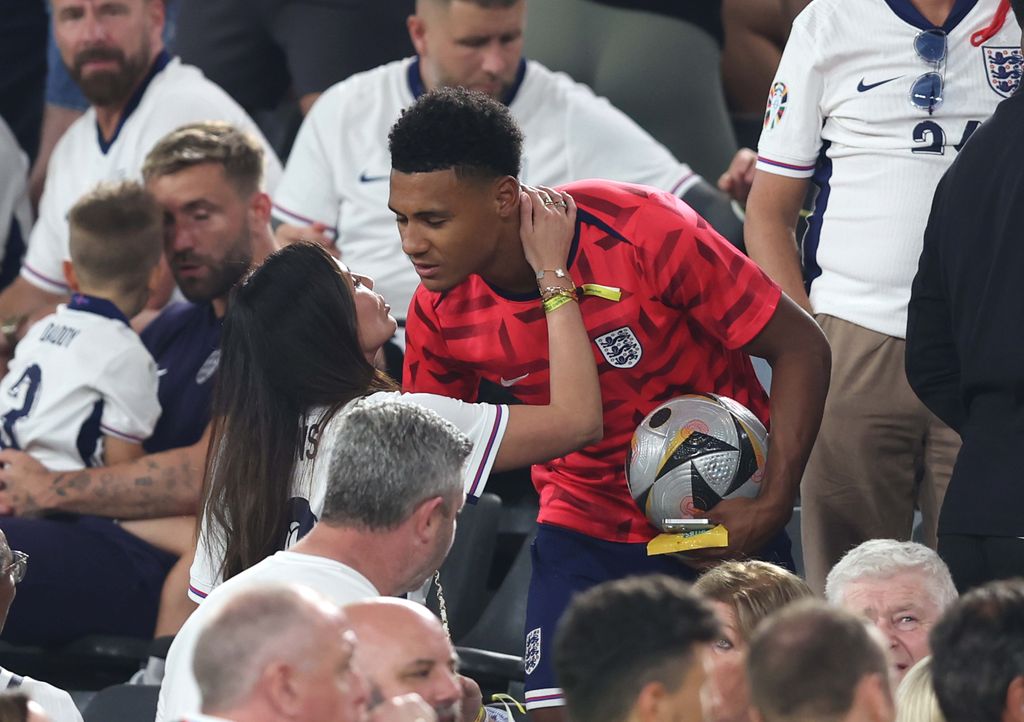 couple embracing in football stands