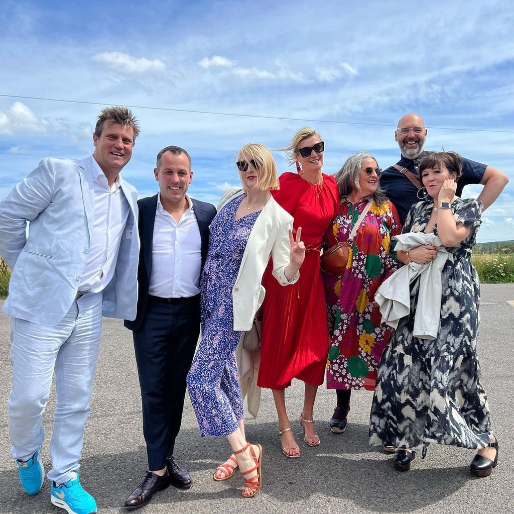 Zoe Ball with friends in a red wedding guest dress and sunglasses