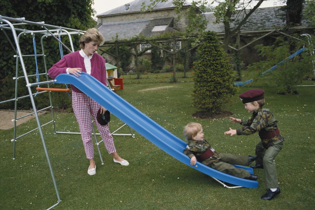Princes William and Harry wearing the uniform of the Parachute Regiment of the British Army in the garden of Highgrove House in Gloucestershire, 18th July 1986. They are accompanied by their mother, Diana, Princess of Wales 