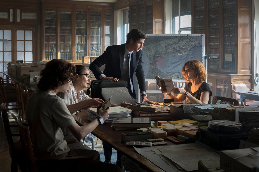 group of people sitting at desk in library