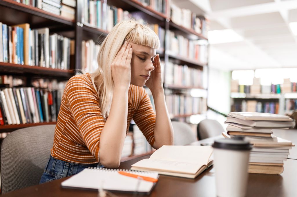 Woman student with headache and university burnout