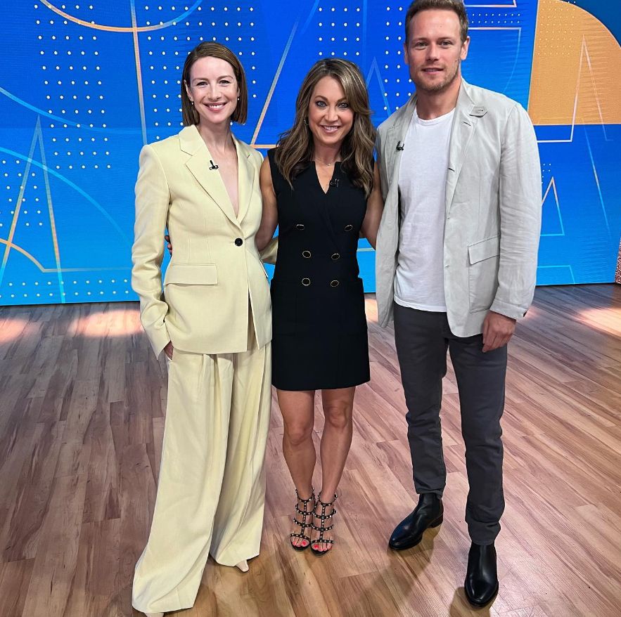 Ginger Zee in black mini dress standing with Catriona Balfe and Sam Heughan