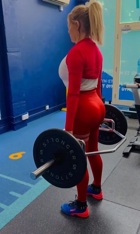 Backshot of Carol Vorderman lifting weights