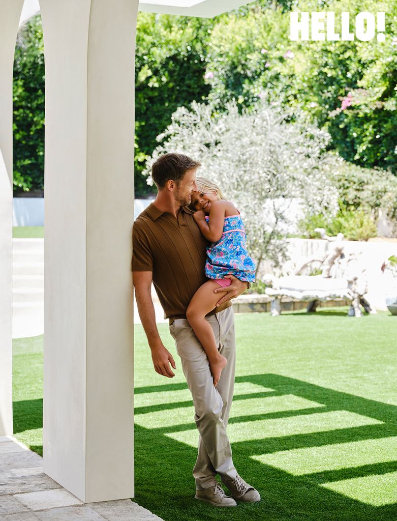 Jenson Button holding his daughter posing at family home 