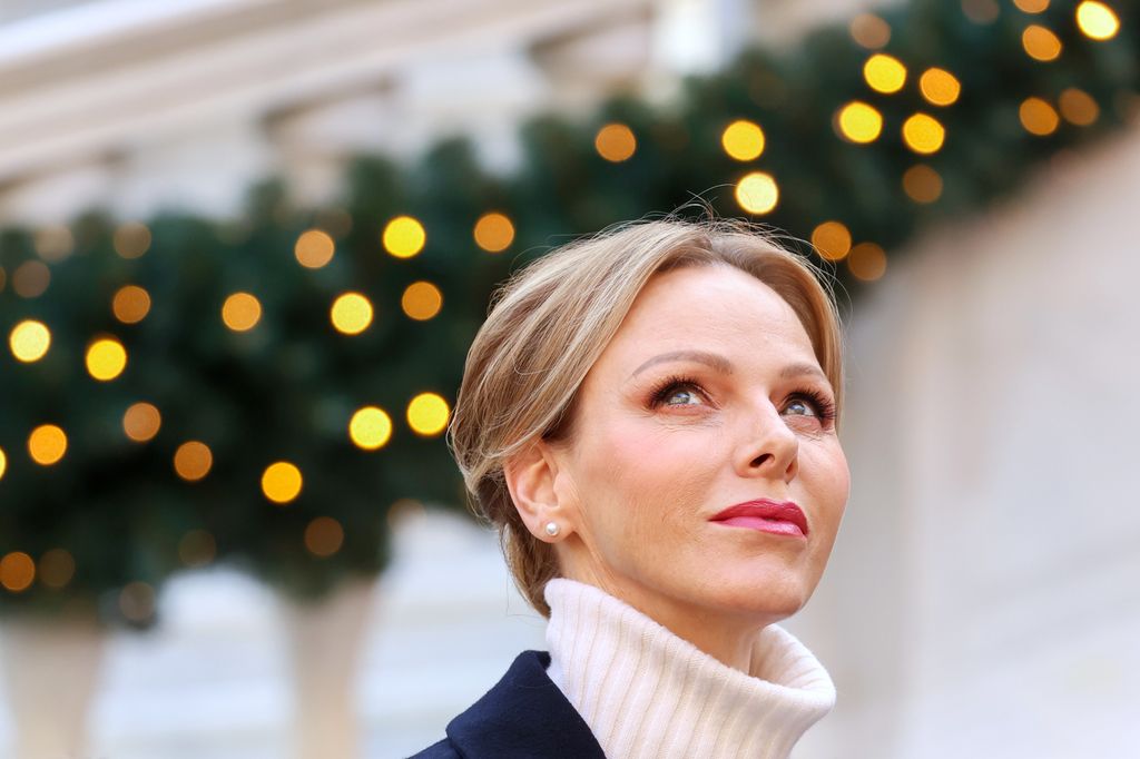 Princess Charlene looking upwards with hair up