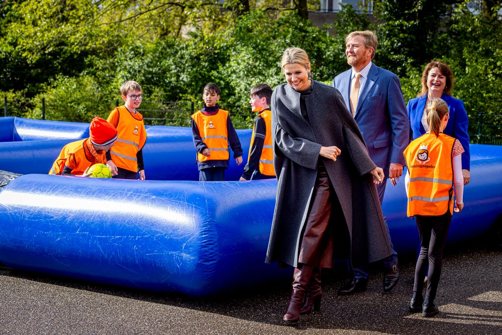 Queen Maxima in leather culottes and boots at school visit