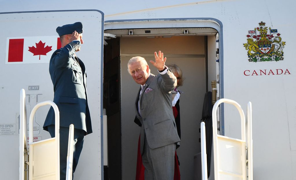 King Charles waving from a plane