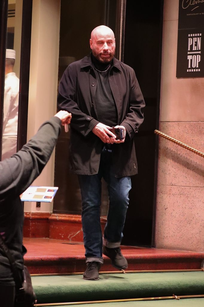 John Travolta steps out in style, donning a black turtleneck paired with jeans and a chain necklace, as he is spotted leaving his New York City hotel.