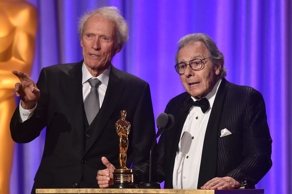 Clint Eastwood introduces Argentinian composer Lalo Schifrin (R) accepting an honorary Oscar at the 10th Annual Governors Awards gala in 2018