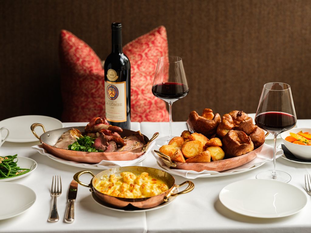 A Sunday roast with wine glasses at Origin City