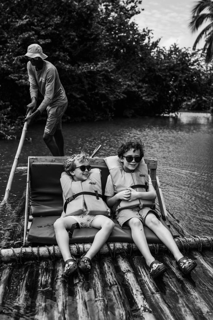 The children enjoying our bamboo rafting adventure down the tranquil waters of the Roseau River