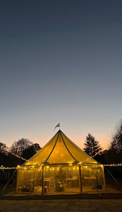 tent with fairylights at sunset
