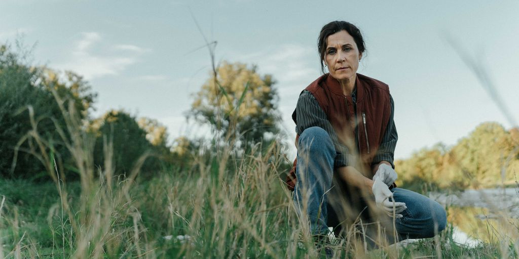 woman kneeling in field