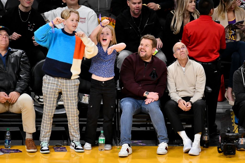 James Corden watches his kids Max Corden and Carey Corden dance during a timeout of a basketball game between the Los Angeles Lakers and the Los Angeles Clippers at Crypto.com Arena on January 24, 2023 in Los Angeles, California