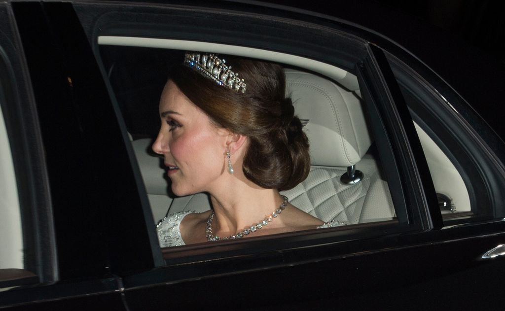 Kate in car in white dress and tiara