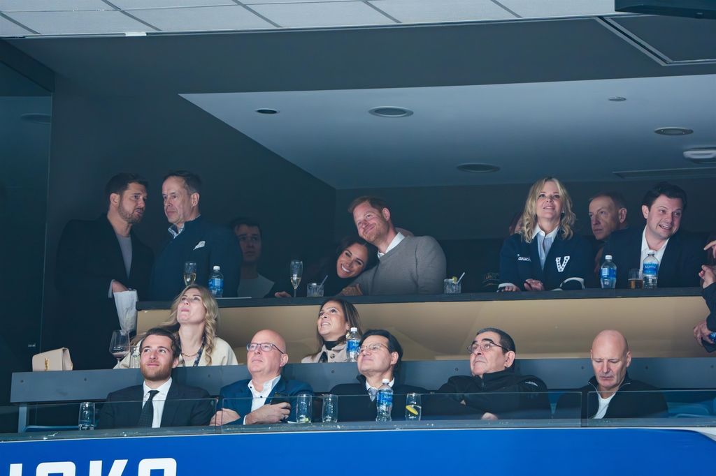 couple smiling and hugging in VIP section of Rogers Arena 