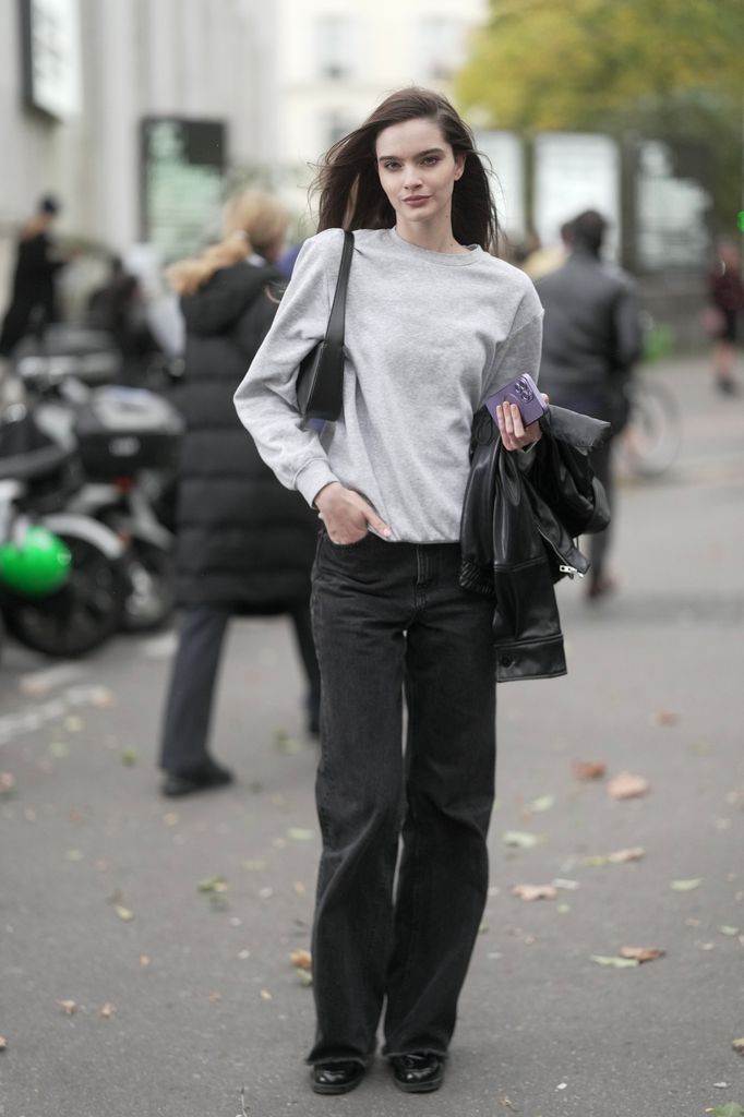 Vira Boshkova is seen wearing a grey sweater, black pants, black boots and carrying a black handbag outside of Elie Saab during the Womenswear Spring Summer 2026 as part of Paris Fashion Week 