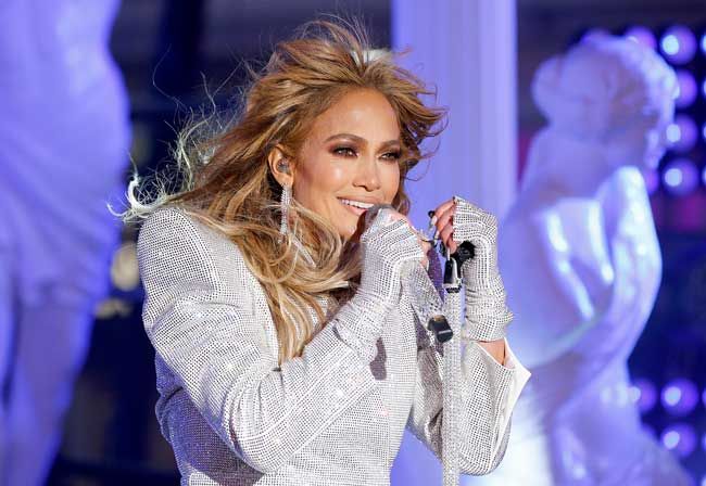 jennifer lopez performing in a glitzy suit