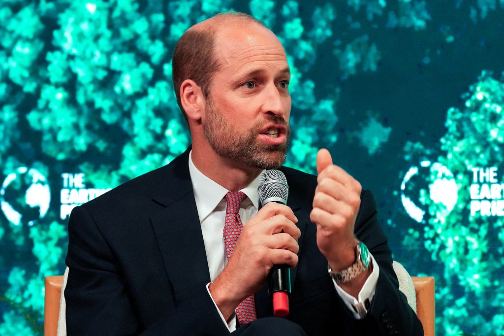 Prince William on stage holding mic