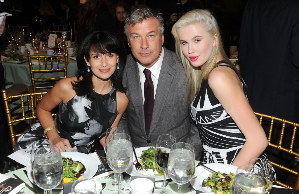 photo of hilaria baldwin alec baldwin and ireland baldwin sitting at round table