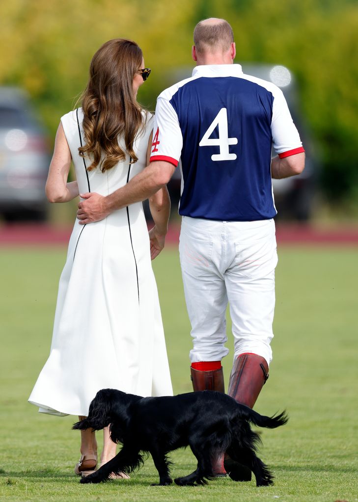 Prince William placing his hand on the small of her back whilst being followed by their dog 'Orla'