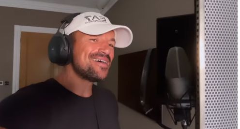 Peter Andre singing into a microphone