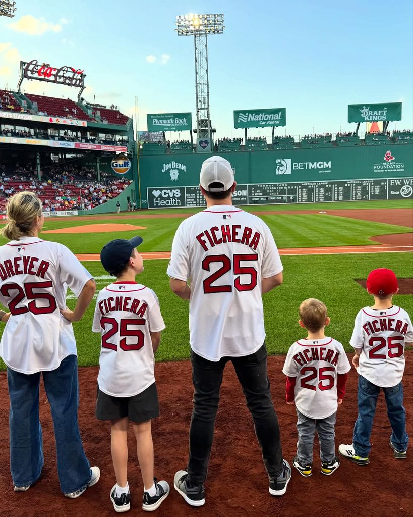Dylan dreyer and her family posing at the boston red sox game