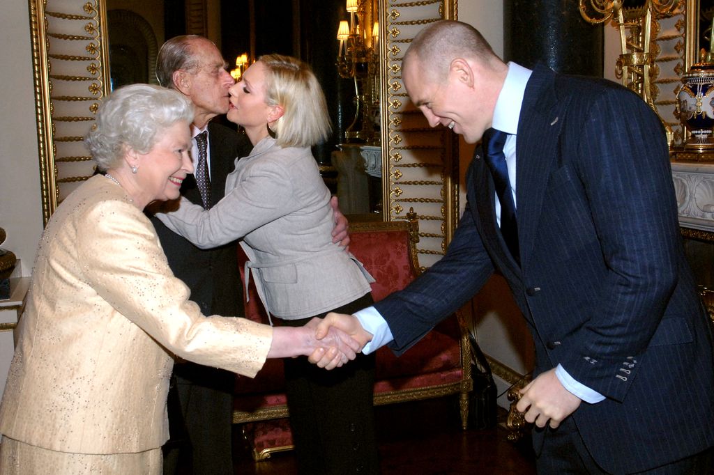 Britain's Queen Elizabeth II and the Duke of Edinburgh meet Zara Phillips and her boyfriend, England rugby player Mike Tindall at a Buckingham Palace reception to honour the country's top achievers.   (Photo by Stefan Rousseau - PA Images/PA Images via Getty Images)