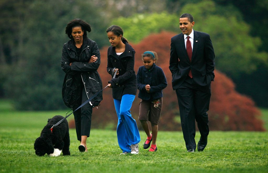 U.S. President Barack Obama (R), first lady Michelle (L) and their daughters, Malia (2nd L) and Sasha (3rd L) introduce their new dog