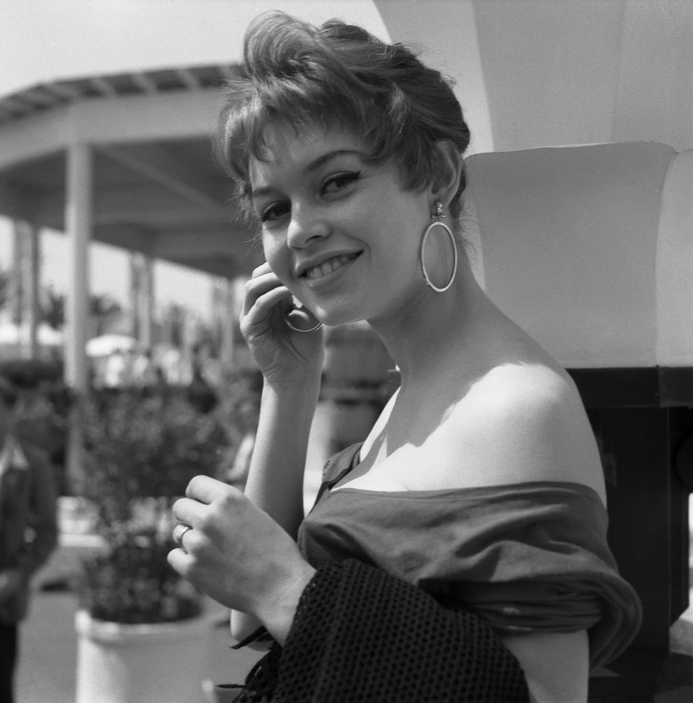 Brigitte Bardot, french model, singer and actress, at Cannnes Movie Festival, wearing a nude-back shirt and big round earrings, Cannes, 1955. (Photo by Archivio Cameraphoto Epoche/Getty Images)