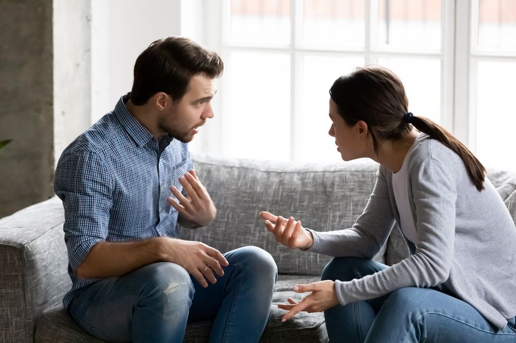 man and woman arguing in living room