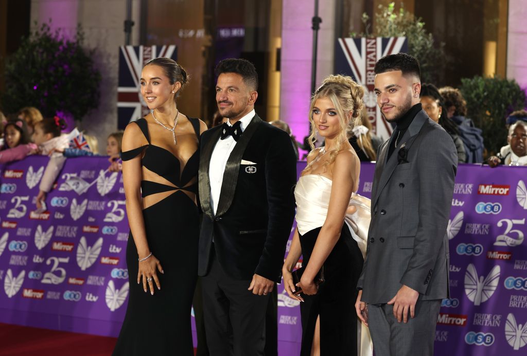 family posing on red carpet