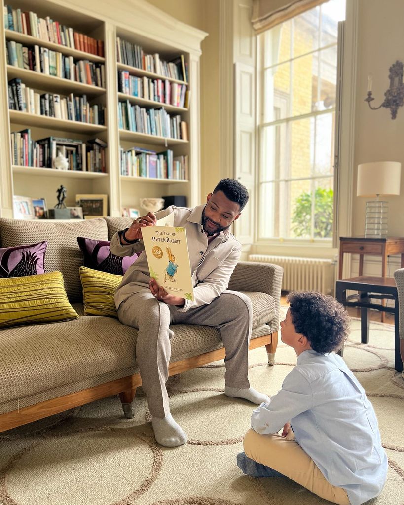 JB inside his farmhouse living room with child 