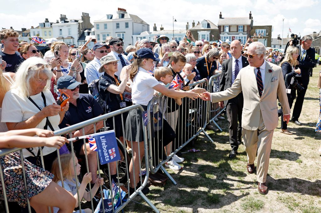 King Charles III interacts with members of the public