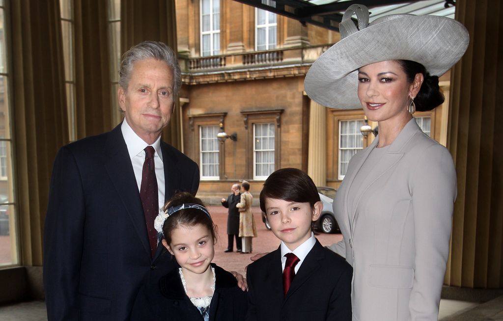 Catherine Zeta-Jones posing with her husband Michael Douglas and their children outside Buckingham Palace